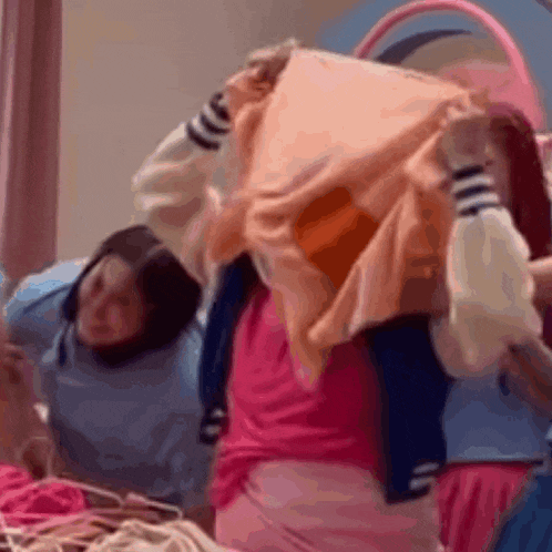 a group of girls are standing next to each other in a room .