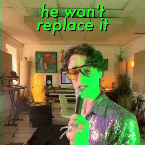 a man singing into a microphone with the words " he won 't replace it " above him
