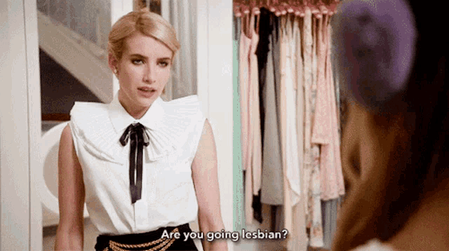 a woman standing in front of a closet asking if she is going lesbian
