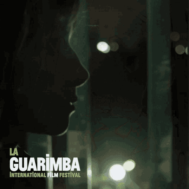 a poster for la guarimba international film festival shows a woman in a dark room