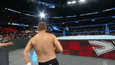 a wrestler in a wrestling ring with the word smack on the side of the ring