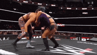 two women are wrestling in a wrestling ring on a wrestling show .