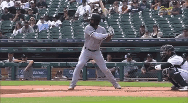 a baseball player with the number 8 on his jersey getting ready to bat
