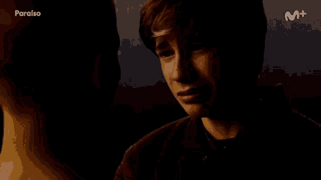 a young boy is crying in a dark room with the word paraiso on the bottom