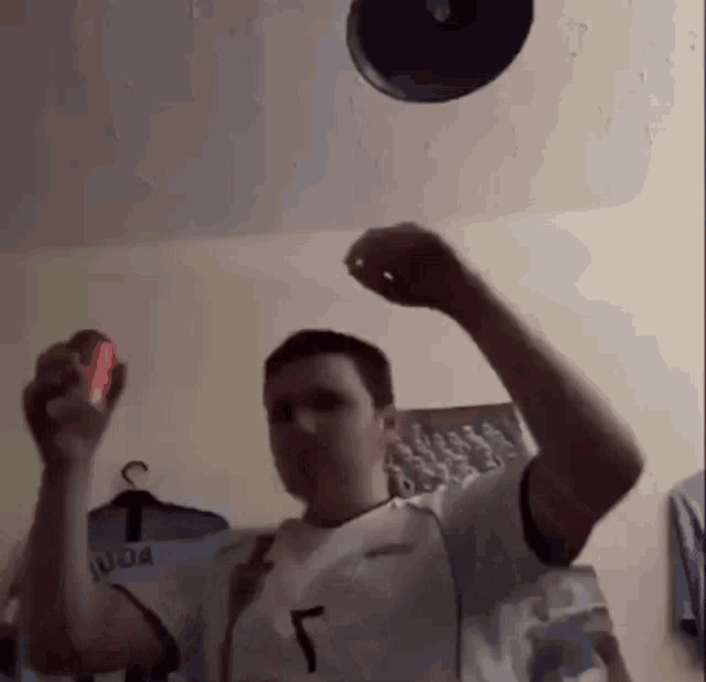 a man is holding a can of soda in his hand and throwing a frisbee in the air .