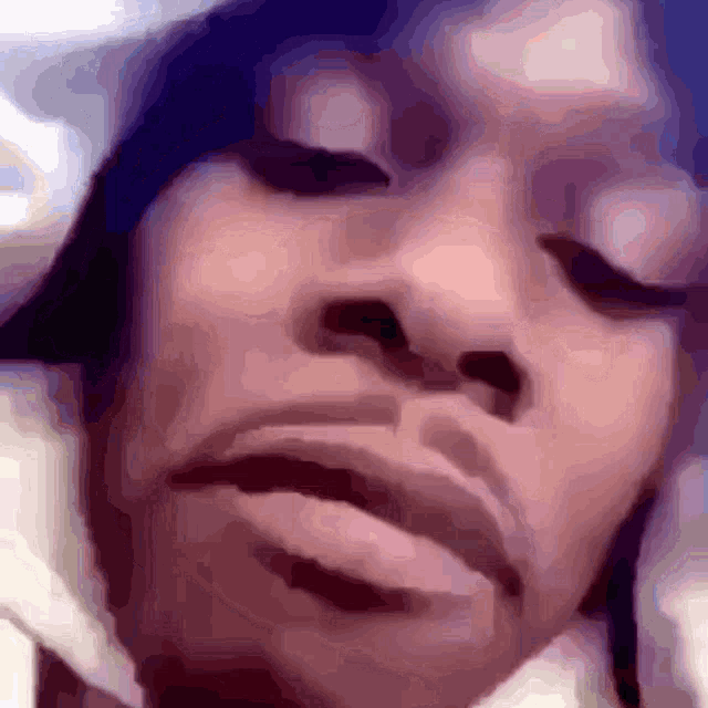 a close up of a person with their eyes closed