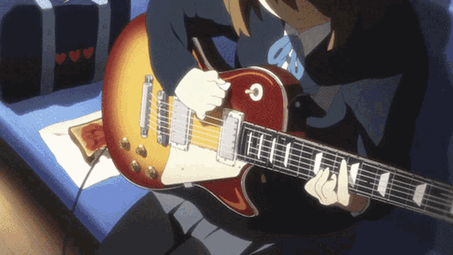 a person playing a guitar with the letter c on the fretboard