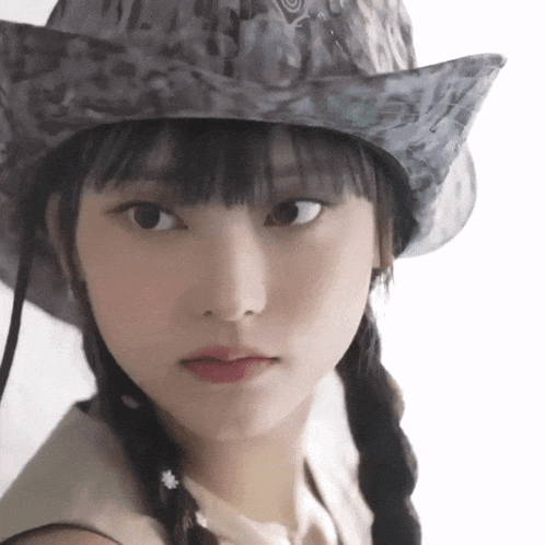 a close up of a woman wearing a hat