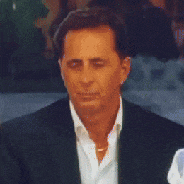 a man in a suit and white shirt is smiling