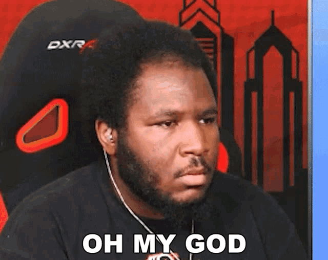 a man with a beard says oh my god in front of a dxr chair