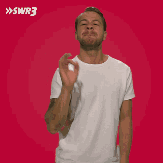 a man in a white shirt making an ok sign with swr3 written on the bottom