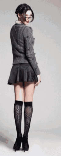 a woman wearing glasses and knee high socks is standing