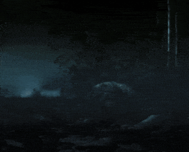 a silhouette of a person in a dark forest at night