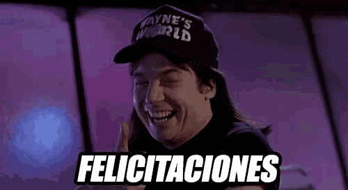 a man wearing a wayne 's world hat is smiling and holding a sign that says felicitaciones .