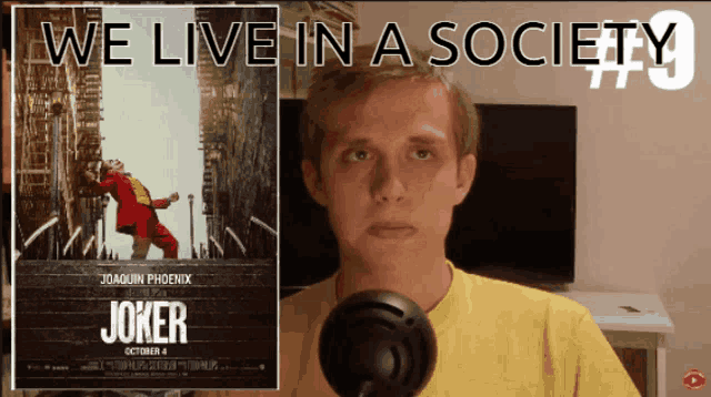a man stands in front of a joker poster