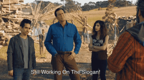 a group of people standing next to each other with the words still working on the slogan above them
