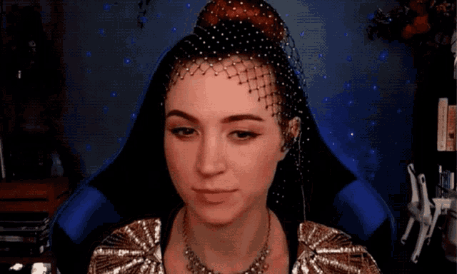 a woman with a veil on her head and a necklace