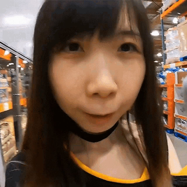 a close up of a woman 's face in a store looking at the camera