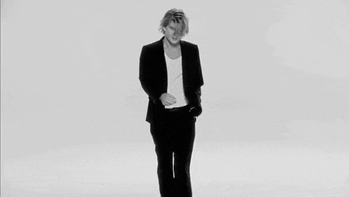 a black and white photo of a young man with blonde hair .