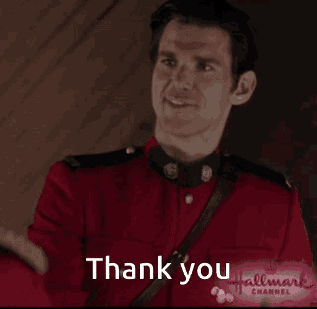a man in a red uniform is smiling and saying " thank you "