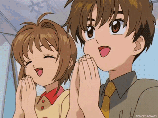 a boy and a girl are standing next to each other with their hands folded in prayer