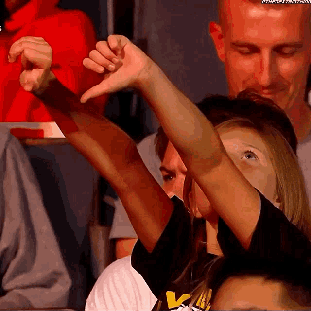 a woman giving a thumbs down sign with the next thing written on the bottom