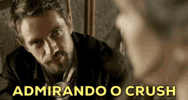 a man with a beard is looking at another man with the words admirando o crush written below him