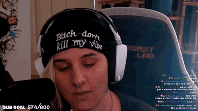a woman wearing a hat that says bitch don t kill my vibe