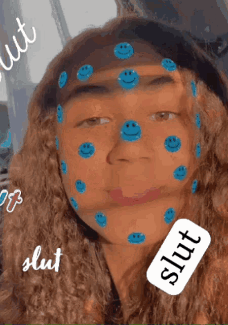 a girl with blue smiley faces on her face has a label that says slut