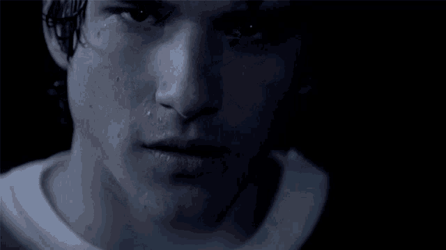 a close up of a man 's face with water drops on it