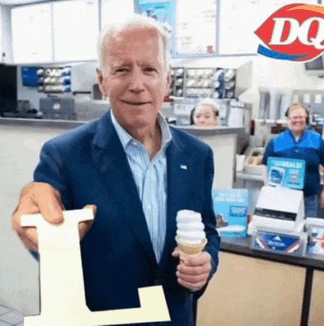 a man in a suit holding an ice cream cone and a letter l