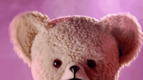 a close up of a teddy bear with lipstick on its face