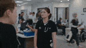 a nurse with a stethoscope around her neck talks to a man