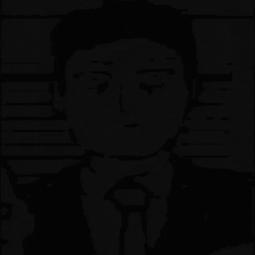 a black and white drawing of a man in a suit and tie looking at the camera .