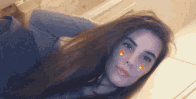 a woman with long brown hair is taking a selfie