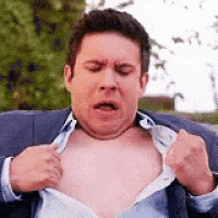 a man in a suit and tie is taking off his shirt .