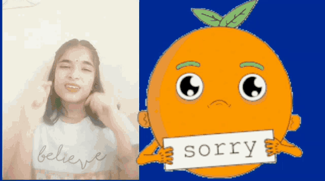 a girl wearing a shirt that says believe next to an orange with a sign that says sorry