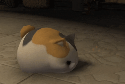 a calico cat is sitting on a tiled floor in a dark room