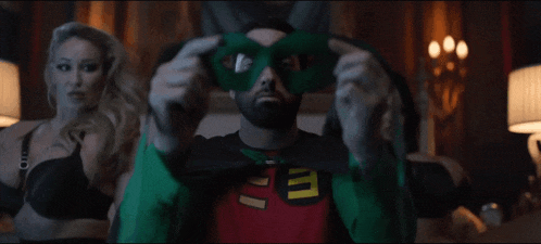 a man in a robin costume has a green mask on his eyes