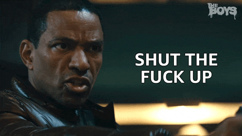 a close up of a man 's face with the words shut the fuck up above him