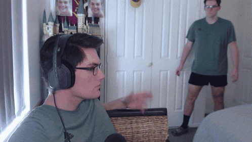 a man wearing headphones and an adidas shirt