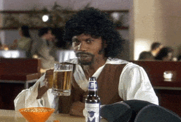 a man in a pirate costume is holding a glass of beer