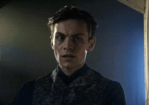 a close up of a man 's face with a serious look on his face