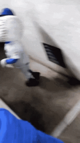 a person in a blue shirt is holding a white object in their hand