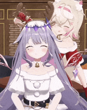 a girl with antlers and a bell around her neck is sitting next to another girl