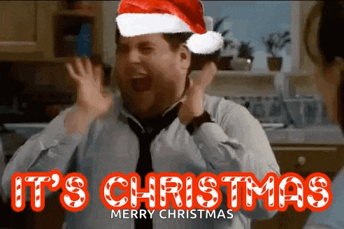 a man wearing a santa hat and tie is celebrating christmas
