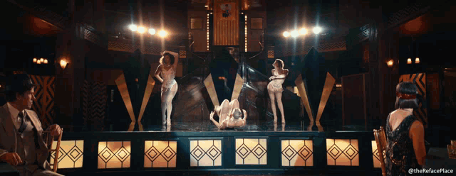 a group of women are dancing on a stage with a caption that says the refaceplace