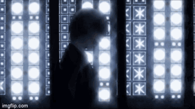 a silhouette of a person standing in front of a row of lights with the words imgflip.com at the bottom
