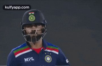 a cricket player wearing a helmet and a mpl jersey