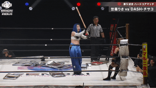 a woman in a wrestling ring holds a bat in front of a referee